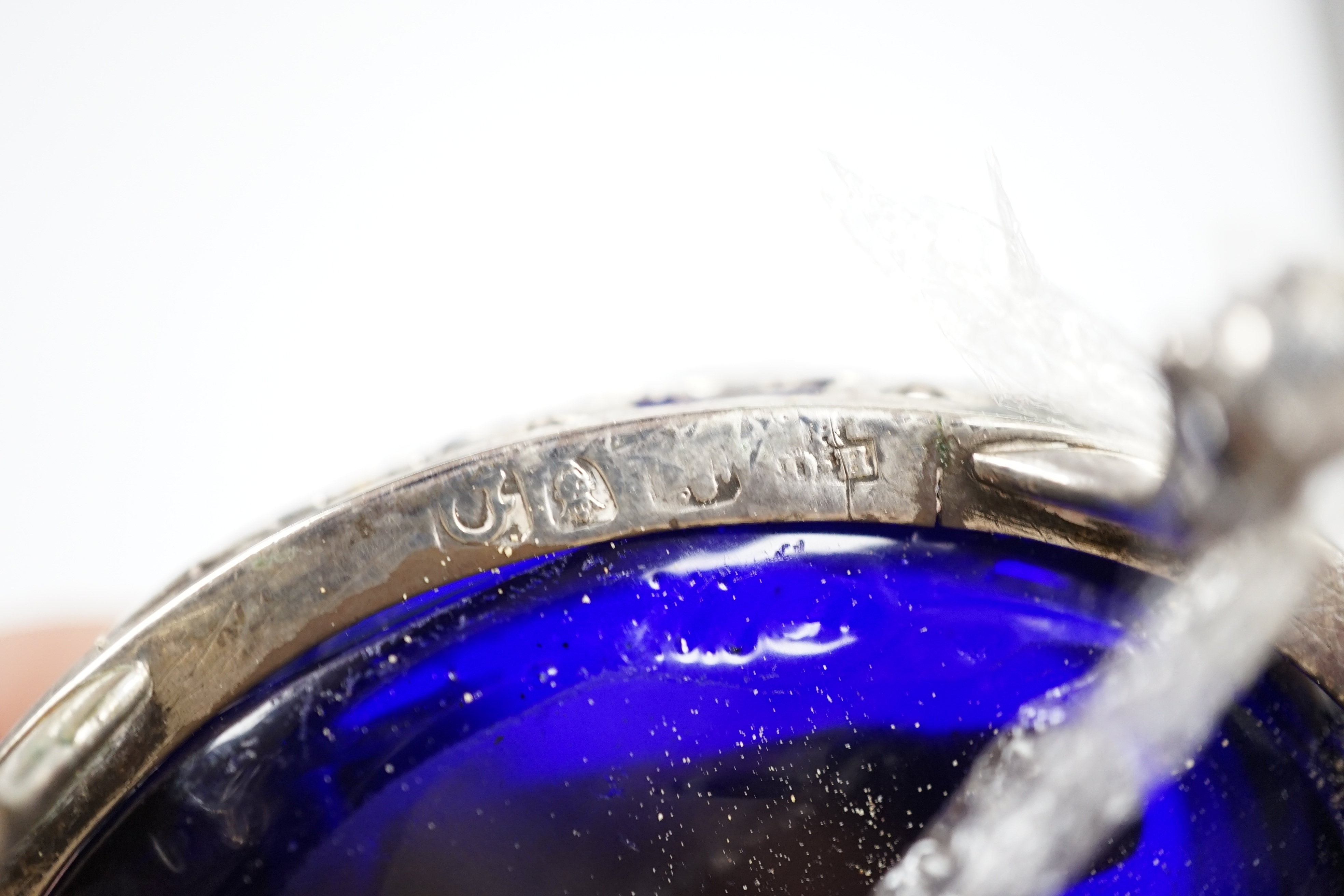 A pair of late George II pierced silver oval salts, by Robert & David Hennell I, London, 1759, with associated blue glass liners, 83mm. Condition - poor